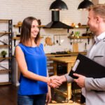 young-woman-shaking-hand-with-businessman