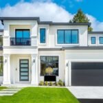beautiful-contemporary-white-house-with-tinted-windows-lush-grass-front-yard-and-blue-sky-ss