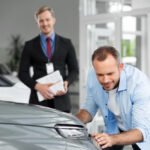 close-up-customer-with-business-person-car-dealership