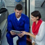 mechanic-using-digital-tablet-with-customer