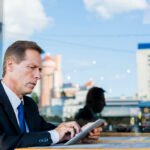 serious-businessman-using-digital-tablet-restaurant
