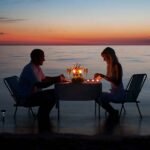 young-couple-having-romantic-evening-with-candles-on-beach